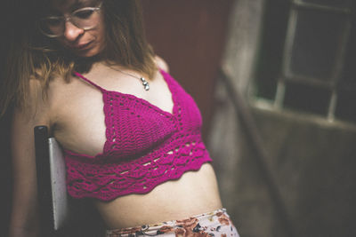 Close-up of young woman wearing bra at home