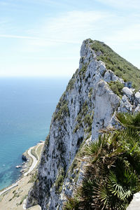 Rock formations by sea against sky