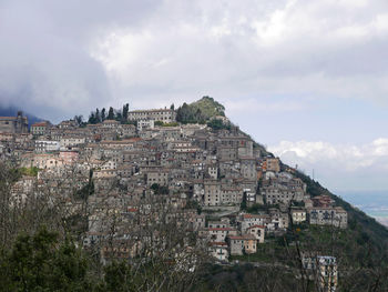 Buildings in town against sky