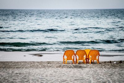 Empty yellow chairs on beach