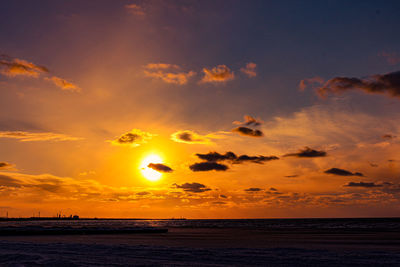 Scenic view of sea against romantic sky at sunset