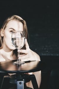 Portrait of a young woman drinking glass