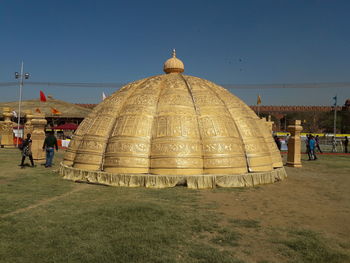 Group of people in temple against clear sky