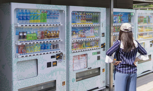 Rear view of woman standing in store