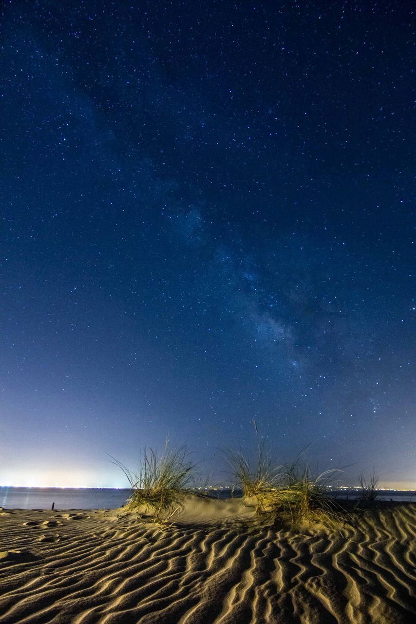 tranquil scene, night, scenics, tranquility, beauty in nature, star - space, astronomy, star field, nature, sky, beach, star, galaxy, idyllic, landscape, space, majestic, blue, sand, infinity