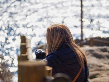 Rear view of woman photographing sea