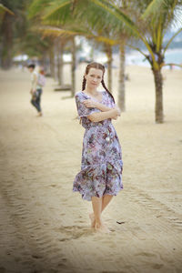 Full length of woman standing at beach