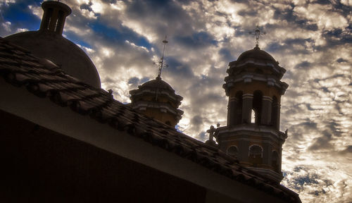 Low angle view of temple against cloudy sky