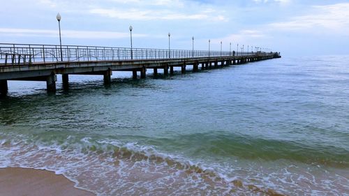 Pier over sea against sky