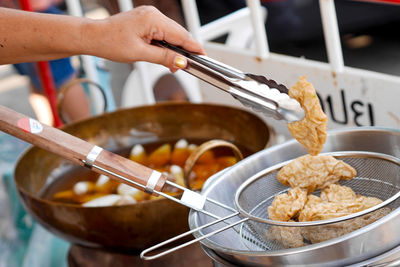 Cropped hand preparing food