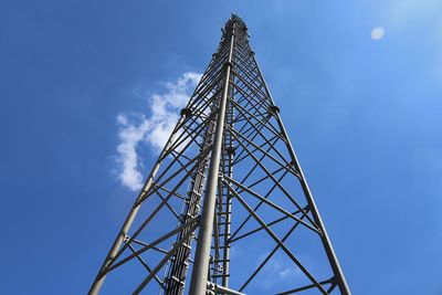 Low angle view of communications tower against blue sky