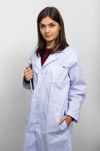 Portrait of woman standing against white background