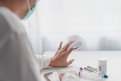 Midsection of doctor examining patient