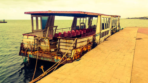 Ship moored in sea against sky