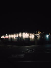 Illuminated street lights in city at night