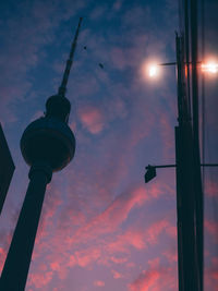 Low angle view of illuminated street light against sky at sunset