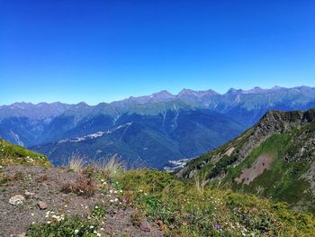 Scenic view of mountains against clear blue sky