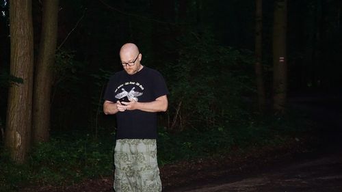 Full length of a man standing in forest