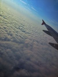 Airplane flying over sea against sky