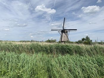 Low angle view of windmill against sky