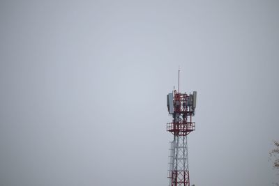 Low angle view of communications tower against sky