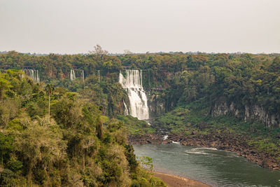 Scenic view of waterfall against clear sky