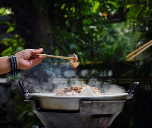 Thailand style bbq grill on a charcoal fire that is located on the bottom with pork, shrimp, squid 