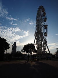 Low angle view of ferris wheel against sky