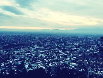 Aerial view of cityscape against sky