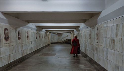 Rear view of woman walking in building