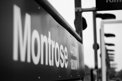 Close-up of information sign at railroad station