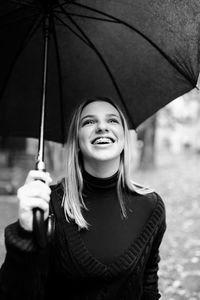 Portrait of a smiling young woman in rain