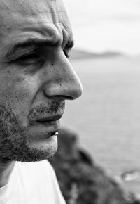 Close-up of thoughtful man by sea
