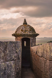 Built structure against sky during sunset