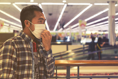 Man wearing mask standing at store