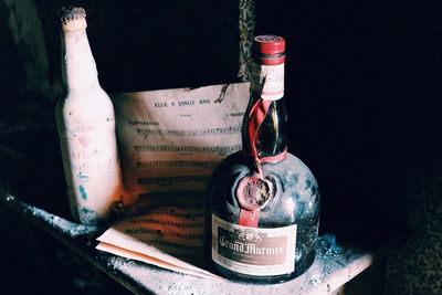 Close-up of wine glass bottle against black background