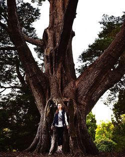 Full length of woman standing by tree against sky