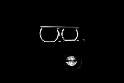 Close-up of illuminated light bulb in darkroom