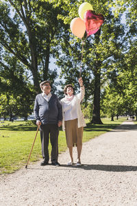 Senior couple with balloons in a park