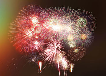 Low angle view of firework display at night