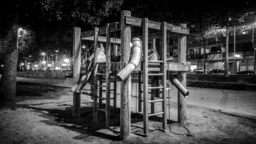 Playground against trees at night