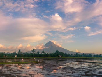 Scenic view of lake against sky during sunset
