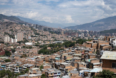 High angle view of houses in comuna 13 in medellin against sky