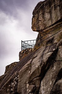 Low angle view of rock formation on mountain against sky