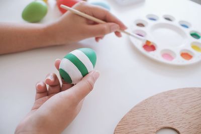 Midsection of woman holding multi colored candies