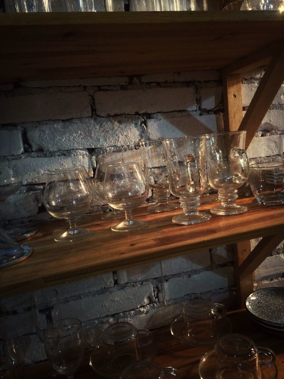 indoors, table, glass - material, drinking glass, transparent, wineglass, still life, drink, food and drink, refreshment, glass, wood - material, water, restaurant, empty, close-up, no people, reflection, arrangement, window