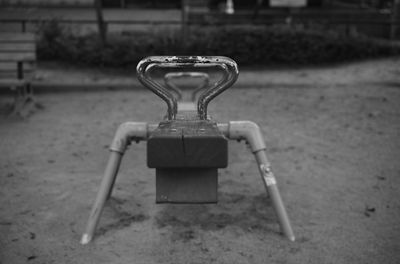 Close-up of empty bench in park