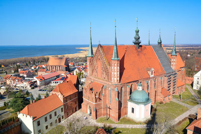 High angle view of townscape by sea against sky