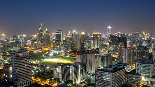 Aerial view of city lit up at night