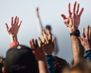 People raising hands in event
